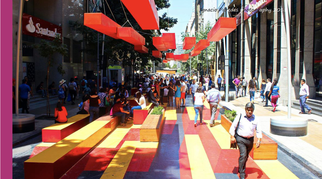Concept rendering of a colorful community promenade with seating and shade structures